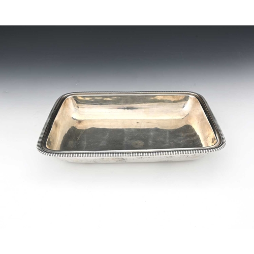 179 - A George III silver entree dish base, of rounded rectangular form, with gadroon edge border, with in... 