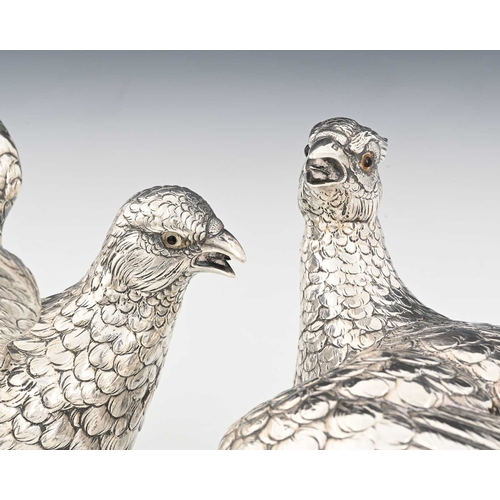 195 - A pair of late nineteenth or early twentieth-century German silver pheasant table ornaments, compris... 