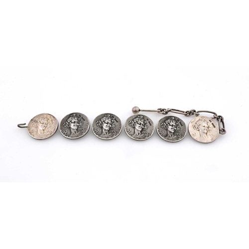 207 - A set of six Art Nouveau silver buttons, each decorated with a maiden's head, modelled in relief, tw... 