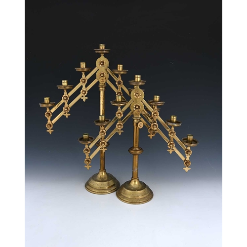 231 - A pair of Gothic Revival brass adjustable candelabra, Maurice Vanpoulle, Westminster circa 1900, eac... 