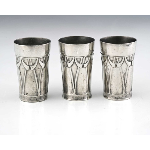 232 - A set of three Jugendstil pewter liqueur beakers, cylindrical form cast in relief with horn and tend... 