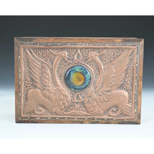 256 - An Arts and Crafts copper clad and Ruskin set box, the lid repousse embossed in relief with two grif... 