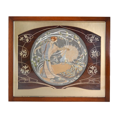 273 - An Art Nouveau silk embroidered roundel, a maiden with peacocks, inset into a painted wooden frame w... 