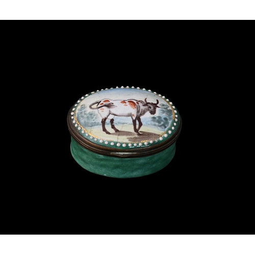 311A - A Bilston enamel patch box, circa 1790, oval form, painted with a short horned cow, within jewelled ... 