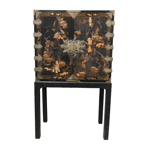 369 - A Chinese export black lacquer cabinet on stand, Qing dynasty, chinoiserie decorated with extensive ... 