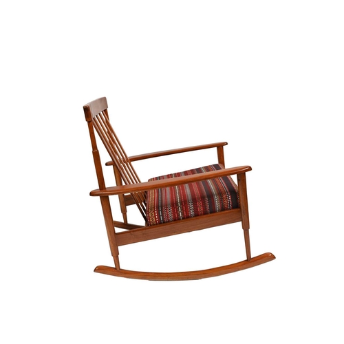 384 - A mid-Century Danish wooden rocking chair, bar back, the seat cushion re-upholstered in Paul Smith '... 