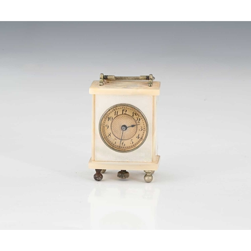 388 - A miniature mother-of-pearl travel clock, dial with black Arabic numerals and outer minute track, pe... 