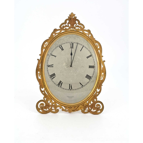 394 - London & Ryder, 17 New Bond St, London, a late 19th Century gilt metal easel desk timepiece, oval wi... 