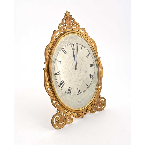 394 - London & Ryder, 17 New Bond St, London, a late 19th Century gilt metal easel desk timepiece, oval wi... 