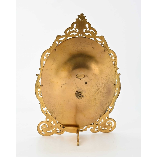 394 - London & Ryder, 17 New Bond St, London, a late 19th Century gilt metal easel desk timepiece, oval wi... 