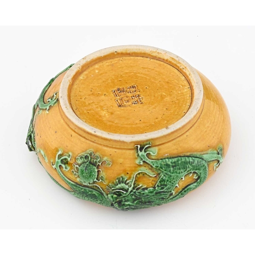 403 - A Chinese porcelain relief moulded water pot, Tang style colours of yellow and green, modelled with ... 