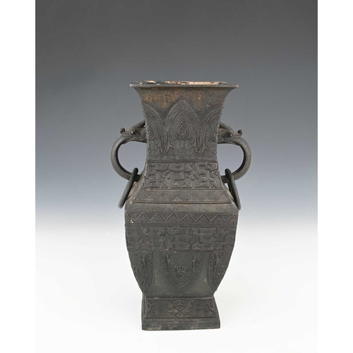 404 - A Chinese bronze vase, inverse baluster rectangular section, with zoomorphic ring handles, in the ar... 