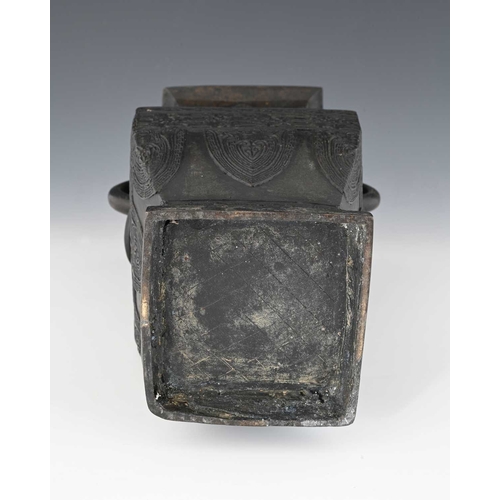 404 - A Chinese bronze vase, inverse baluster rectangular section, with zoomorphic ring handles, in the ar... 