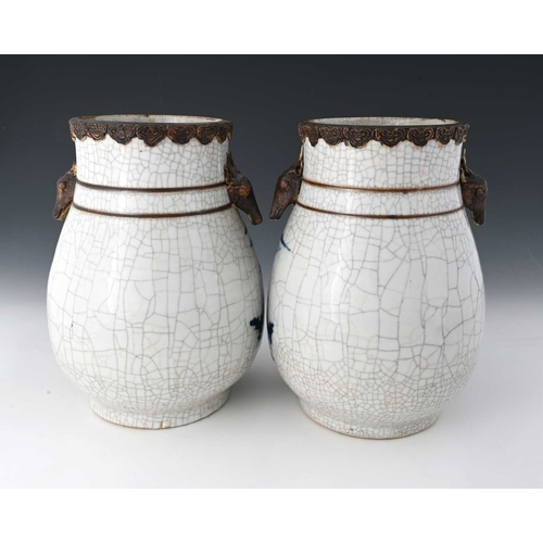 410 - A pair of Chinese blue and white vases, squat baluster form with craquelure glaze and rusticated rim... 