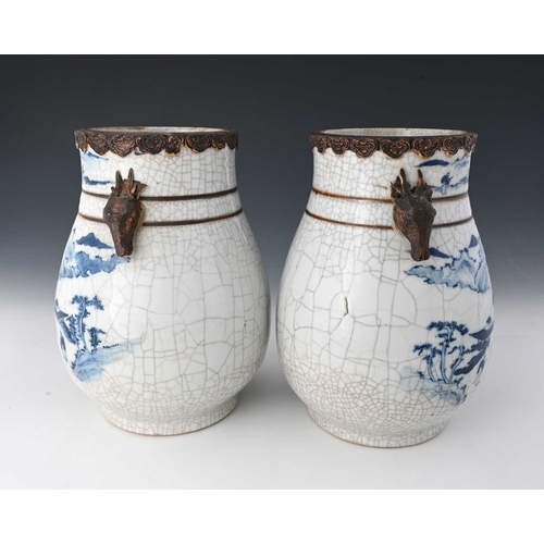 410 - A pair of Chinese blue and white vases, squat baluster form with craquelure glaze and rusticated rim... 