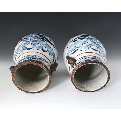 410 - A pair of Chinese blue and white vases, squat baluster form with craquelure glaze and rusticated rim... 