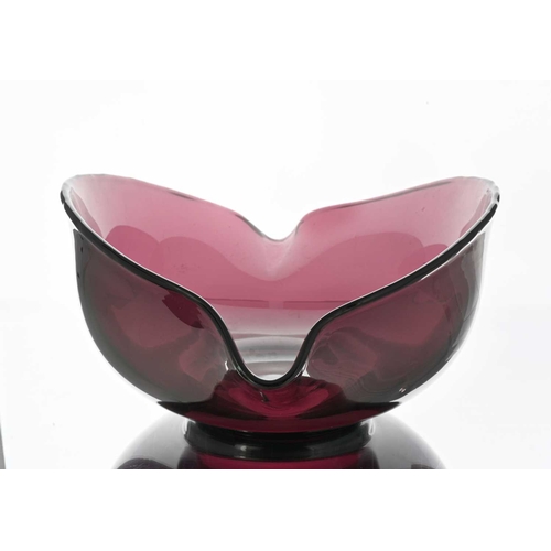 632 - A large 19th century amethyst glass dairy bowl, possibly Bristol, pinched and footed with two lips, ... 