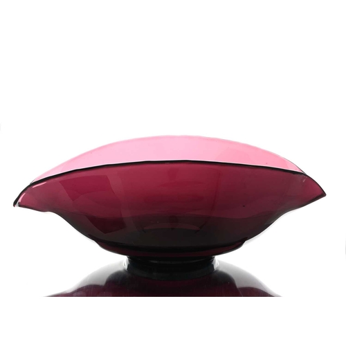 632 - A large 19th century amethyst glass dairy bowl, possibly Bristol, pinched and footed with two lips, ... 