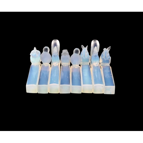 667 - Etling, a set of eight Art Deco opalescent glass knife rests, circa 1925, each modelled with a fores... 