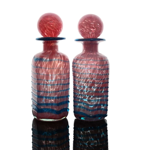 681 - Mdina, a pair of studio glass decanters, or bottles, circa 1980, hexagonal section bases, pink marbl... 