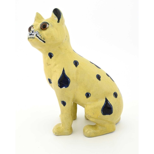 690 - A faience figure of a pug dog, in the Mosanic/Galle style, modelled sitting upright, yellow ground w... 