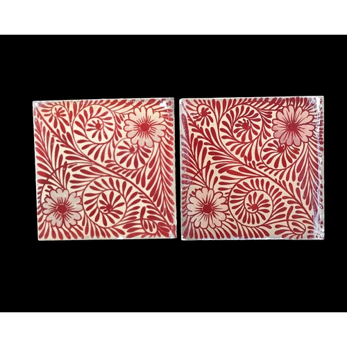 699 - William De Morgan, a pair of foliate ruby lustre tiles, Chelsea, circa 1880, with two flowers to eac... 