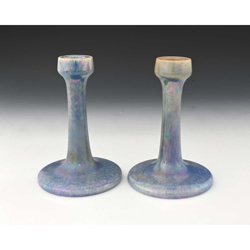 734 - Ruskin Pottery, a pair of lavender Lustre candlesticks, 1925, splayed form with poppy head sconces, ... 