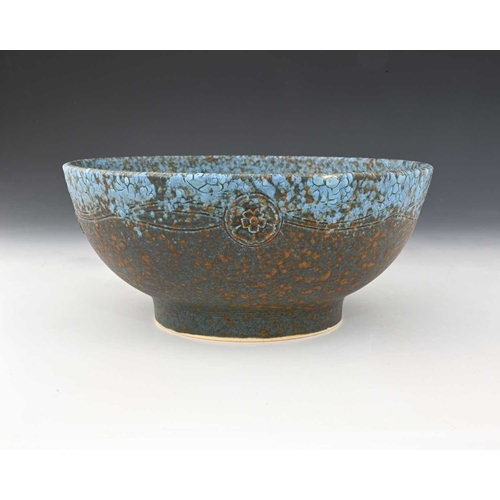 736 - Ruskin Pottery, a relief moulded Crystalline bowl, circa 1932, footed form, applied with rosettes un... 