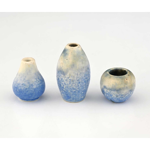 744 - Ruskin Pottery, three miniature Crystalline vases, greenish cream over pale blue, including barrel, ... 