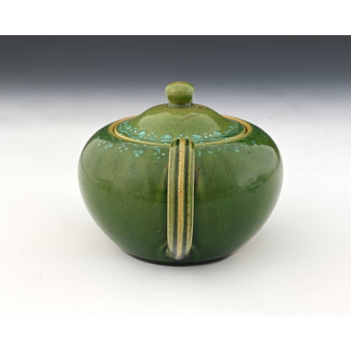 755 - Ruskin Pottery, a Souffle and slip decorated teapot, circa 1900, quat ovoid form, green tocky glaze ... 