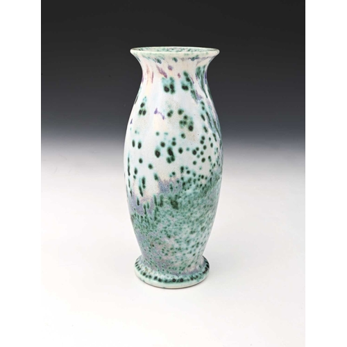 767 - Ruskin Pottery, a High Fired vase, circa 1910, footed barrel form with everted rim, mottled and spec... 