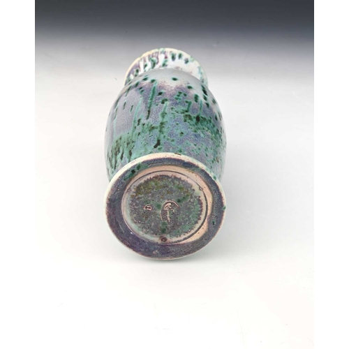 767 - Ruskin Pottery, a High Fired vase, circa 1910, footed barrel form with everted rim, mottled and spec... 