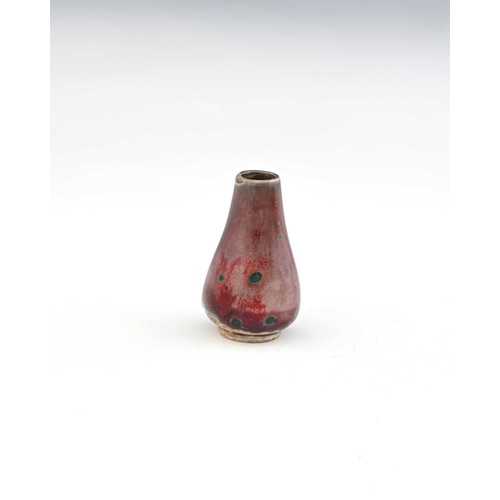 768 - Ruskin Pottery, a miniature High Fired vase, circa 1920, conical baluster form, lavender and sang de... 