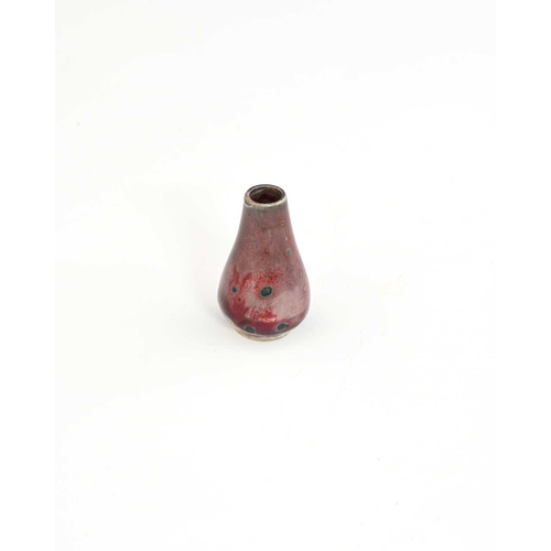 768 - Ruskin Pottery, a miniature High Fired vase, circa 1920, conical baluster form, lavender and sang de... 