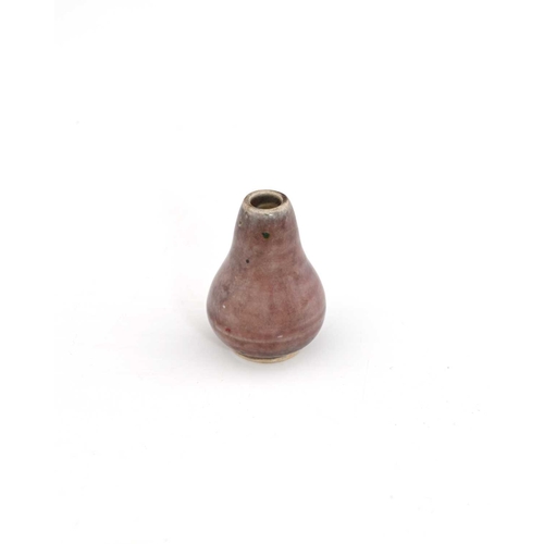 769 - Ruskin Pottery, a miniature High Fired vase, circa 1920, conical gourd form, liver coloured sang de ... 