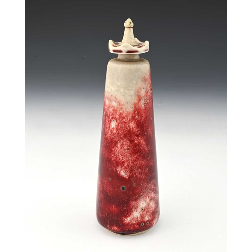 772 - Ruskin Pottery, a High Fired scent bottle, 1927, conical form with crenelated screw top, sang de boe... 