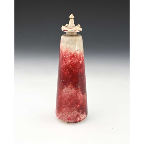 772 - Ruskin Pottery, a High Fired scent bottle, 1927, conical form with crenelated screw top, sang de boe... 