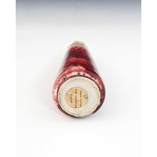 772 - Ruskin Pottery, a High Fired scent bottle, 1927, conical form with crenelated screw top, sang de boe... 