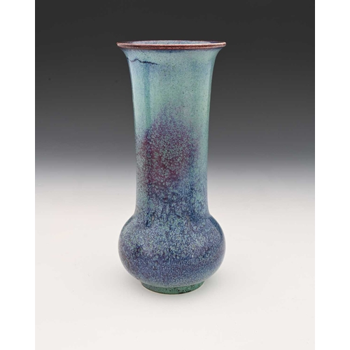 775 - Ruskin Pottery, a High Fired vase, circa 1905, slender bulbous form with elongated cylindrical neck,... 