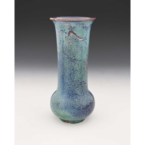 775 - Ruskin Pottery, a High Fired vase, circa 1905, slender bulbous form with elongated cylindrical neck,... 