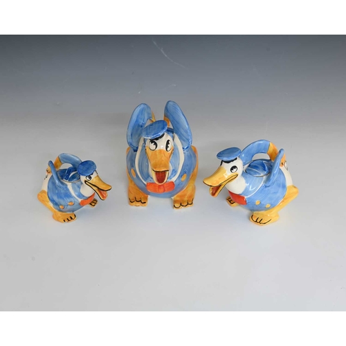 812 - Walt Disney for Wadeheath, a novelty Donald Duck graduated trio of teapots, each modelled in sailors... 