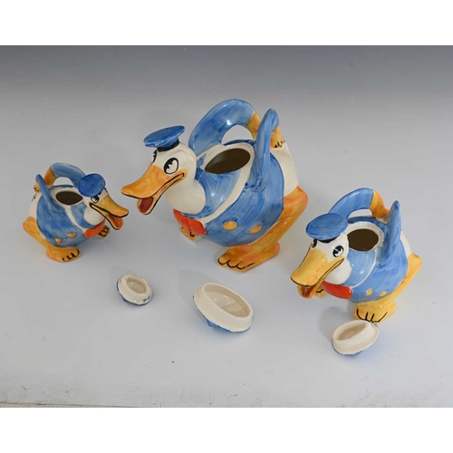 812 - Walt Disney for Wadeheath, a novelty Donald Duck graduated trio of teapots, each modelled in sailors... 