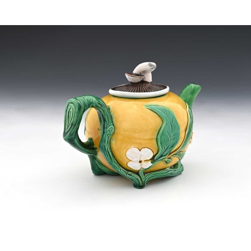 816 - A Minton Majolica teapot, 1862, modelled in relief as a gourd with leafy branch handle and mushroom ... 