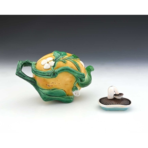 816 - A Minton Majolica teapot, 1862, modelled in relief as a gourd with leafy branch handle and mushroom ... 