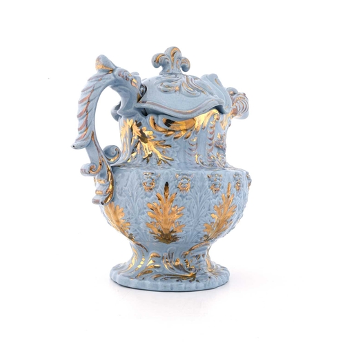 822 - A Rococo moulded lustre decorated lemonade jug and cover, circa 1830, urn form with mask spout and f... 