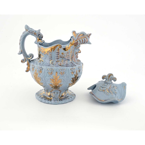 822 - A Rococo moulded lustre decorated lemonade jug and cover, circa 1830, urn form with mask spout and f... 