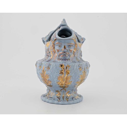 822 - A Rococo moulded lustre decorated lemonade jug and cover, circa 1830, urn form with mask spout and f... 