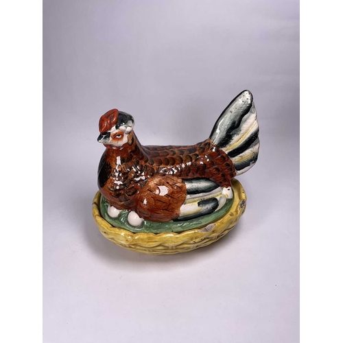 128 - A Staffordshire hen tureen and cover, the brown hen is hand painted with a red crown and black and w... 