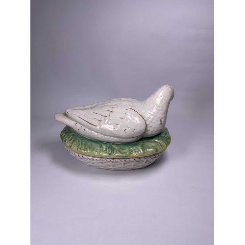 129 - A Staffordshire duck tureen and cover, the mother bird modelled bending her beak towards her young, ... 