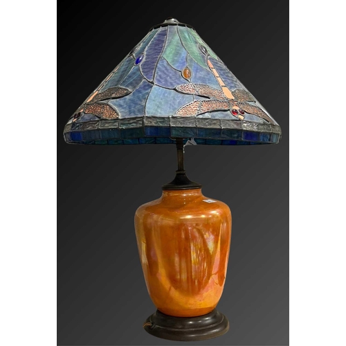 163 - A Ruskin Pottery orange lustre lamp base, with Tiffany style leaded glass shade, shouldered form on ... 